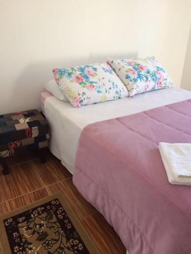 a bed with two pillows on it in a room at Praça Residence in Uruguaiana