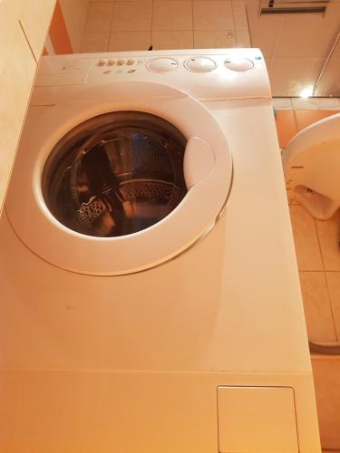 a washing machine with its door open in a bathroom at Pirita River View Apartment new in Tallinn