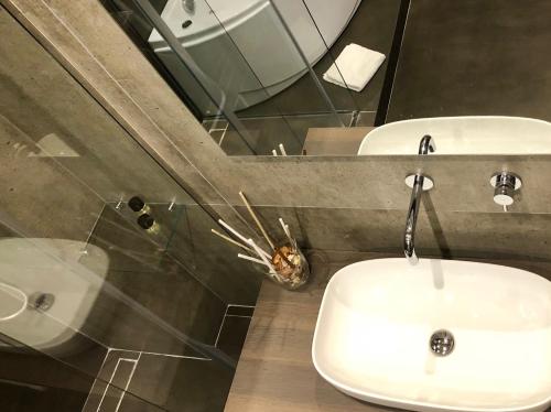 a bathroom with two sinks and a mirror at Dimora Augusteo in Naples