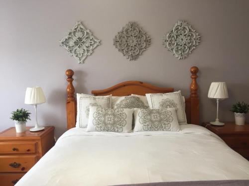a bedroom with a bed with white sheets and pillows at Póvoa City Center Apartment in Póvoa de Varzim