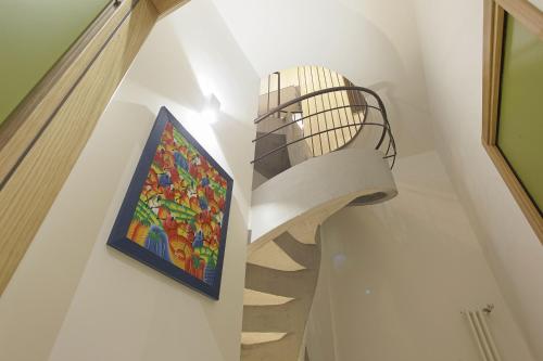 a staircase in a house with a painting on the wall at Casa Tita in Agrigento