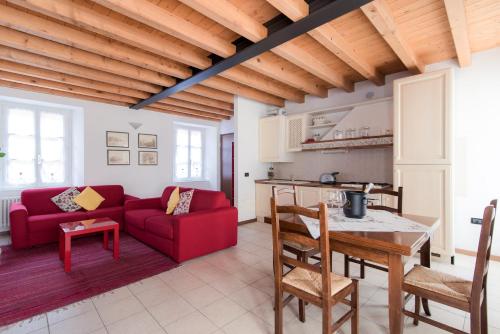 a living room with a red couch and a table at Ca Mia - The House Of Travelers in Como