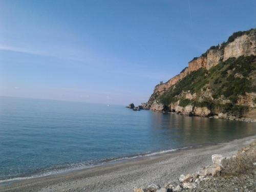 a beach on the side of a cliff at Hotel La Carruba in Cetraro