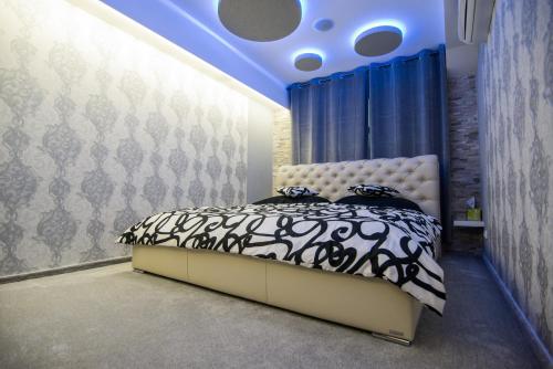a bedroom with a bed with a blue ceiling at Wellness Apartmán Relax in Český Těšín