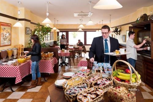 a man standing in front of a table with food at ibis Charleroi Centre Gare in Charleroi