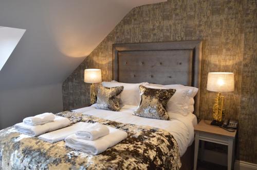 a bedroom with a large bed with towels on it at The Lord Street Hotel; BW Signature Collection in Southport