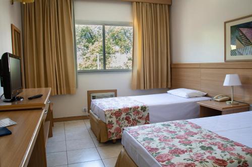 מיטה או מיטות בחדר ב-Hotel Dan Inn São José dos Campos