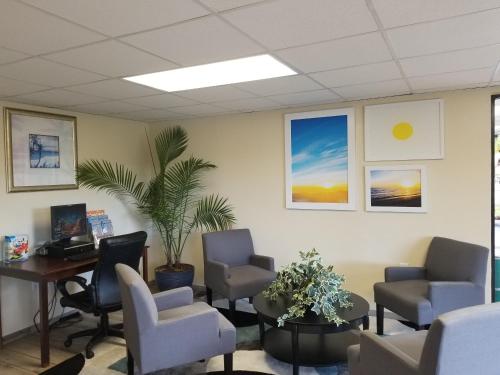 an office with a waiting room with chairs and a desk at Days Inn by Wyndham Clearwater/Central in Clearwater