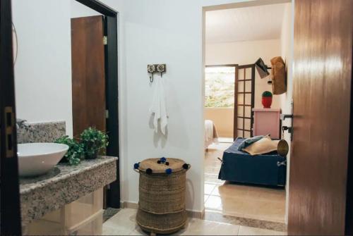 a bathroom with a sink and a bed in a room at Pousada Familia Ottoboni in Cananéia