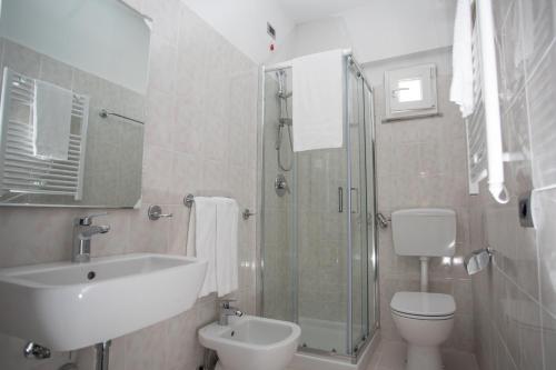 a bathroom with a sink and a toilet and a shower at Bike&Boat Argentario Hotel in Porto Santo Stefano