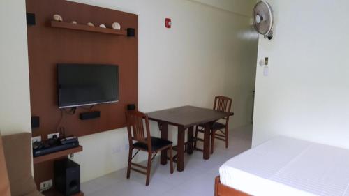 a room with a table and chairs and a bed at Pico De Loro - Myna B Studio in Nasugbu