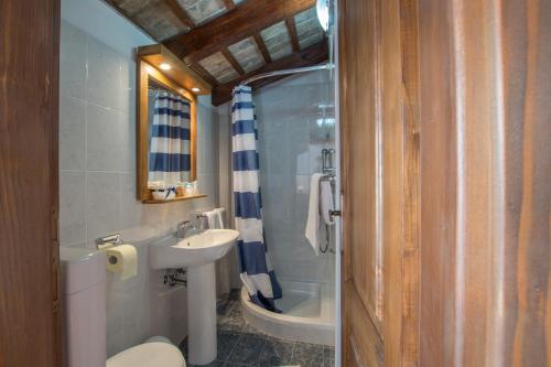 a bathroom with a sink and a toilet and a shower at Villa Belle in Oprtalj