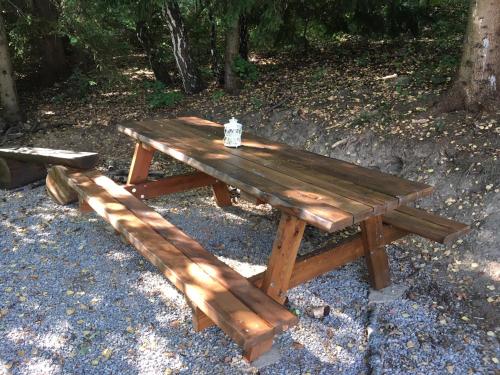 a wooden picnic table with a jar on top of it at Apartmány Planina Predná Hora in Predná Hora