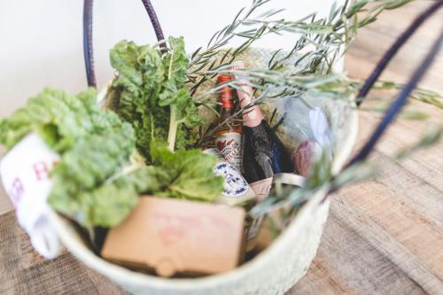 a basket filled with plants on top of a table at The Farmstead in Franschhoek