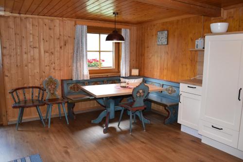 kuchnia ze stołem i krzesłami w pokoju w obiekcie Ferienwohnung Suntinger w mieście Mörtschach