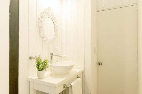 a bathroom with a white sink and a mirror at Zulu Beach in José Ignacio