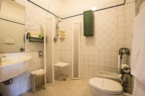 a bathroom with a toilet and a sink at Hotel Kyrton in Forte dei Marmi