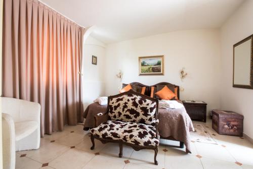 a bedroom with a bed and a chair at Hotel Kyrton in Forte dei Marmi