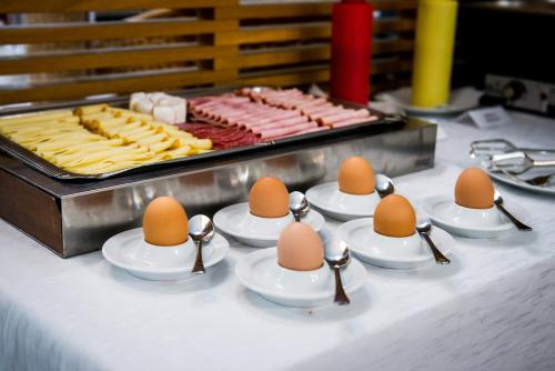 a table with eggs on spoons in a group at Hotel Mlynska in Uherské Hradiště