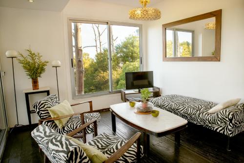 a living room with a zebra print couch and a table at Cdl in José Ignacio
