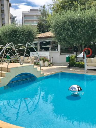 a swimming pool with a silver object in the water at Hotel Bristol in Sottomarina