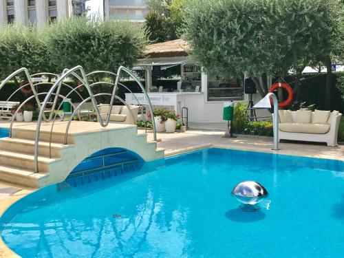 a swimming pool with a silver ball in the water at Hotel Bristol in Sottomarina