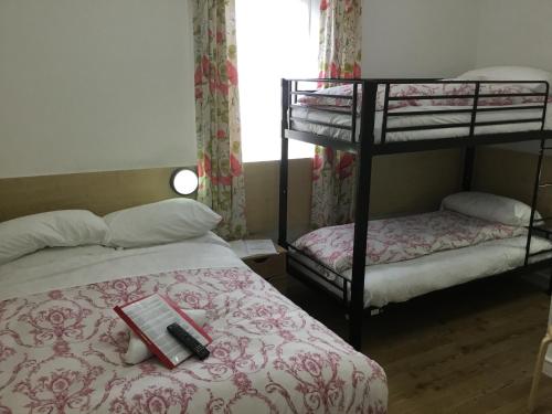 a bedroom with two bunk beds and a book on the bed at The Danescourt in Blackpool