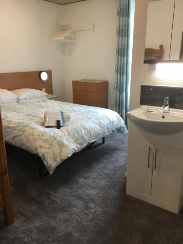 a hotel room with a bed and a sink at The Danescourt in Blackpool