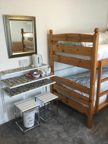 a bedroom with a bunk bed and a mirror at The Danescourt in Blackpool