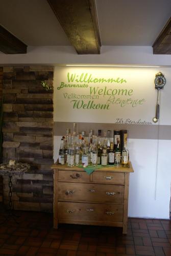 a room with a dresser with bottles on it at Hotel Storchen in Rheinfelden