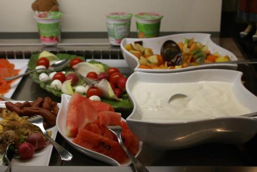 a table with three trays of different types of food at Hotel Storchen in Rheinfelden