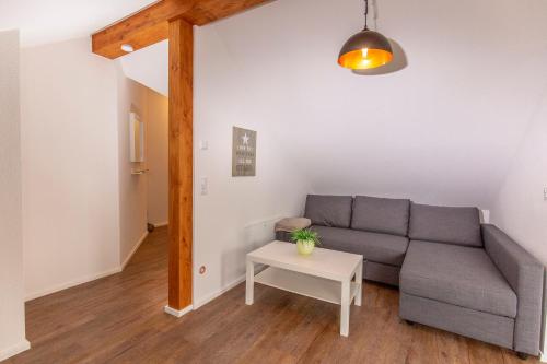 a living room with a couch and a table at Ferienwohnungen "Am Mühlenberg" in Lindlar