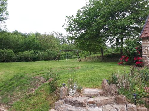 a swing set in the middle of a field at Le BOCAGE in Sartilly