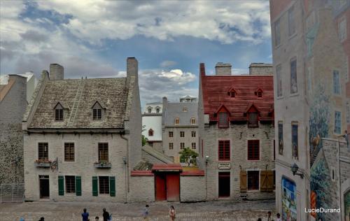 a group of buildings with people walking in a city at Le Studio Cohen "parking inclus" in Quebec City