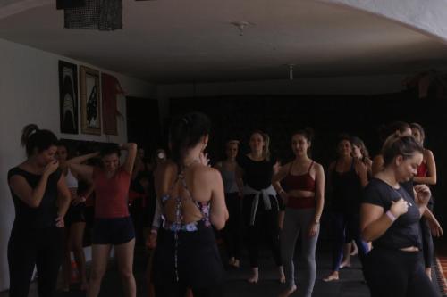 a group of young women dancing in a room at Hostel House 84 in Itajaí