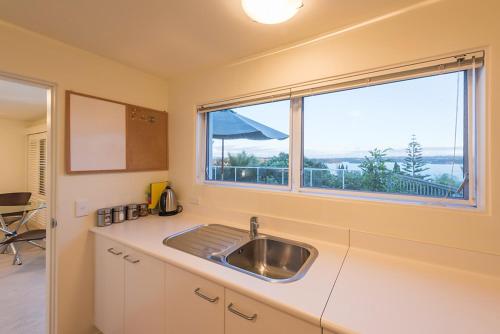 a kitchen with a sink and a window at The Sails in Russell