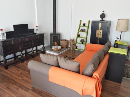 a living room with a couch and a table at Cozy Place in Sintra