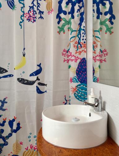 a bathroom with a sink and a mirror at Casa da Pedra - Aljezur, always the sun in Aljezur