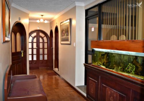a hallway with a fish tank in a room at Kinde House in Quito