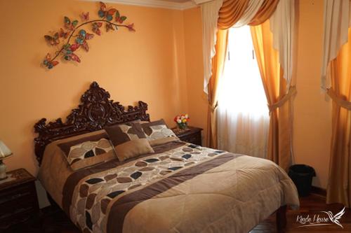 a bedroom with a large bed and a window at Kinde House in Quito