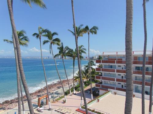 a view of the beach from the balcony of a resort at Hotel Rosita in Puerto Vallarta