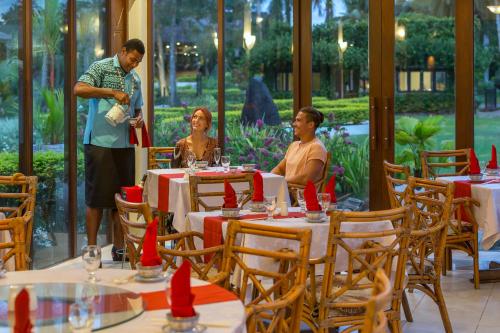 a group of people sitting at tables in a restaurant at The Naviti Resort in Korolevu