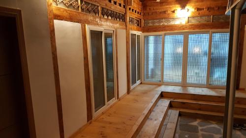 an empty room with windows in a house at Hwangridangil Adamjeong in Gyeongju