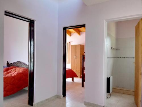 a bedroom with a mirror and a bed in a room at Casa en Mina Clavero in Mina Clavero