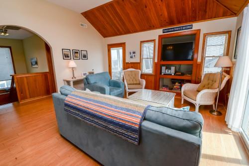 a living room with a couch and a tv at Shore Is Fun in Duck