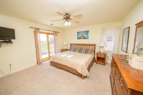 a bedroom with a bed and a ceiling fan at Funtiki in Whalebone