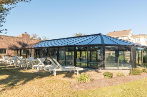 a pavilion with tables and chairs in a yard at Sounds Great! in Duck