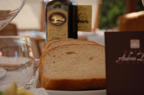 a loaf of bread sitting on a table next to a glass at Andrea Doria Hotel in Marina di Ragusa
