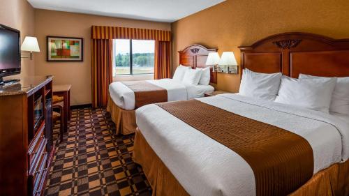 a hotel room with two beds and a flat screen tv at Best Western White Mountain Inn in Franconia