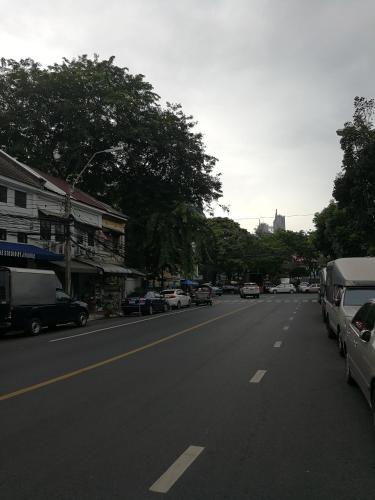 a street with cars parked on the side of the road at Sip N' Camp in Bangkok